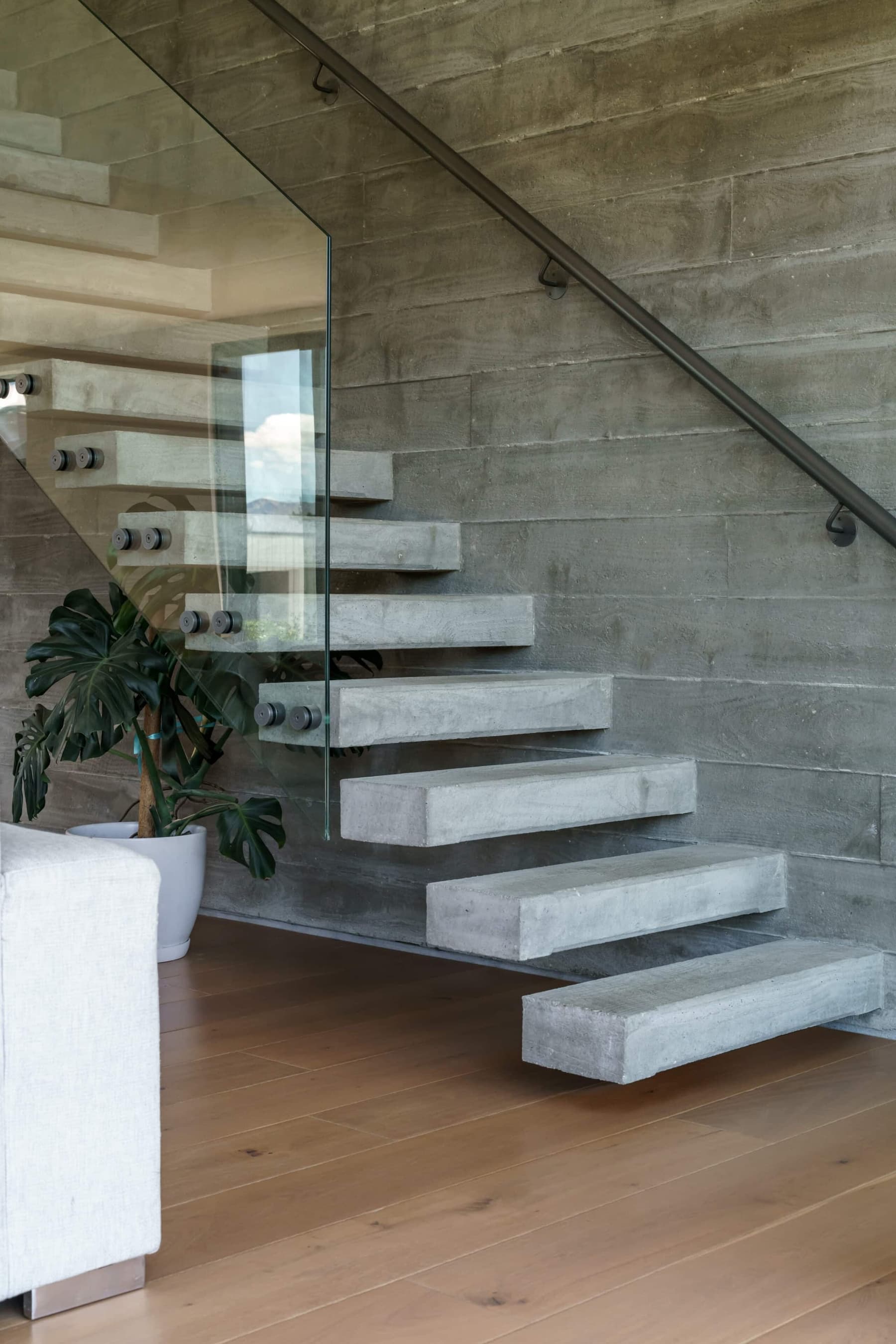 Cantilevered concrete treads against a board-formed wall